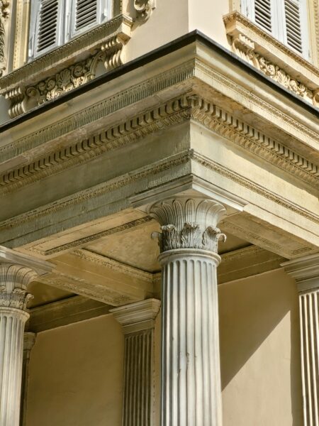 Close-up of neoclassical architecture with ornate columns and pediment detail.