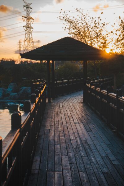 Wooden lakeside pathway with an overhanging roof