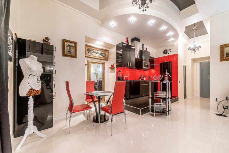 Contemporary red and black kitchen with stylish decor and elegant furniture.