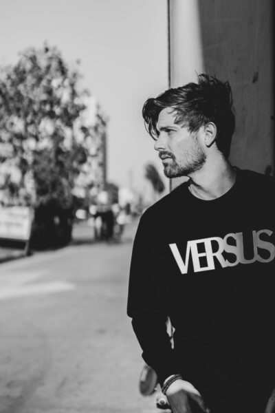 Stylish black and white portrait of a male model in urban Los Angeles setting.