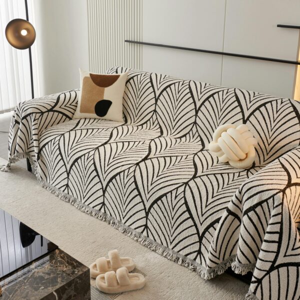 Cozy modern living room with a patterned sofa cover, plush pillows, and elegant decor.