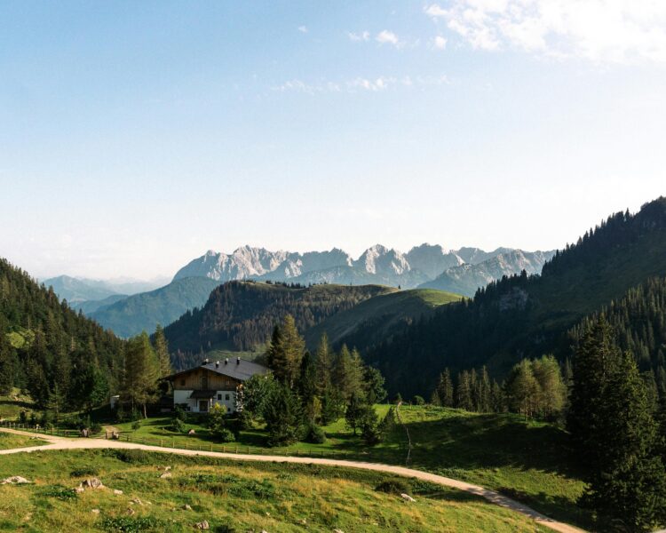 Beautiful alpine landscape with a cozy house and mountains