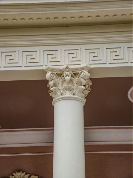 Detailed view of an elegant Ionic column with Greek ornamental design elements, perfect for architecture enthusiasts.