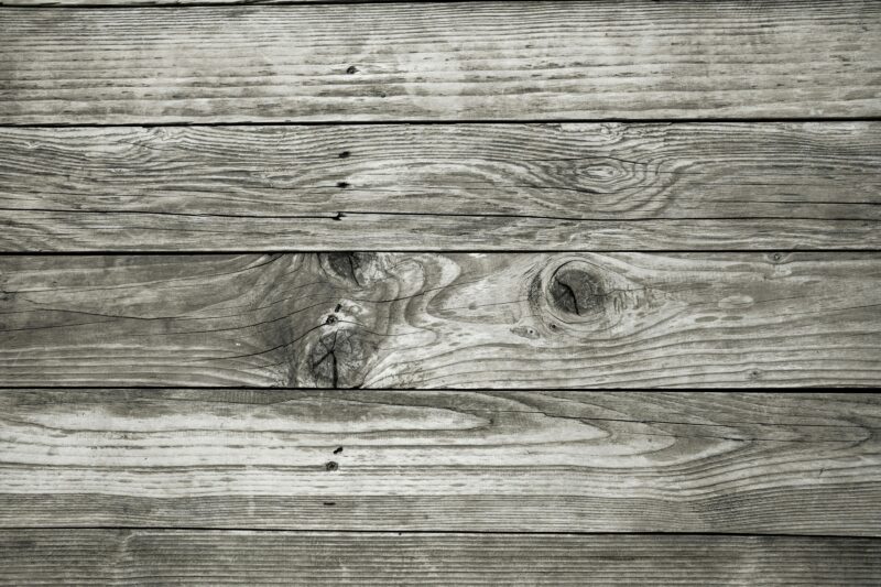 Close-up of rustic wooden planks showing natural grains and knots, perfect for backgrounds.