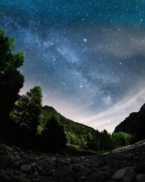 Capture the breathtaking Milky Way over the serene Swiss Alps at night.