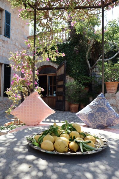 Beautiful Spanish courtyard with lemons and colorful flowers in Ibiza, Spain.