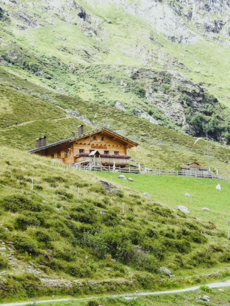 Rustic farmhouse set in the lush green hills of Trentino-Alto Adige, Italy.