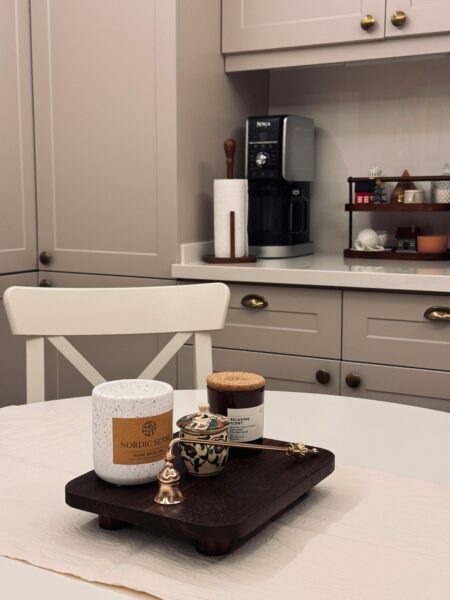 Warm kitchen with a coffee station and stylish decor items.