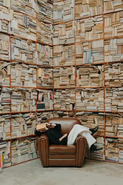 Cozy reading nook in a room full of books.