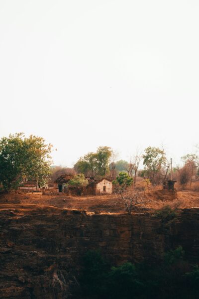 Rural landscape with rustic housing and trees.