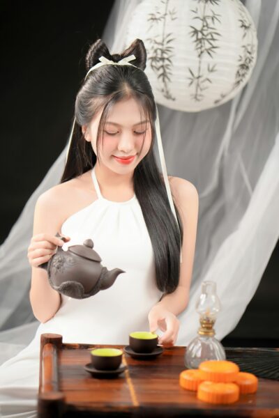 Elegant Asian woman pouring tea in tranquil setting