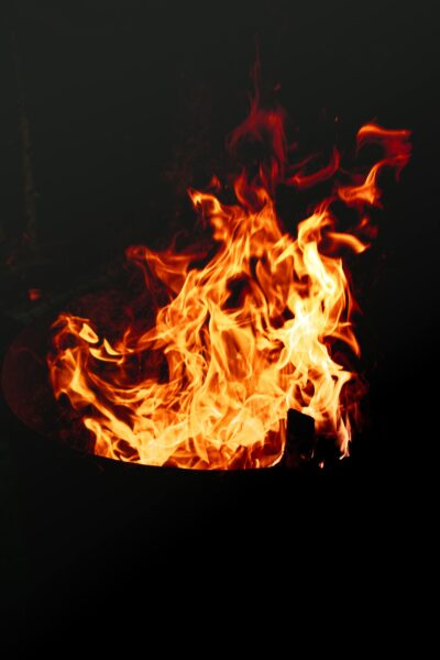 Captivating image of bright flames dancing against a dark background, creating a dramatic and intense scene.
