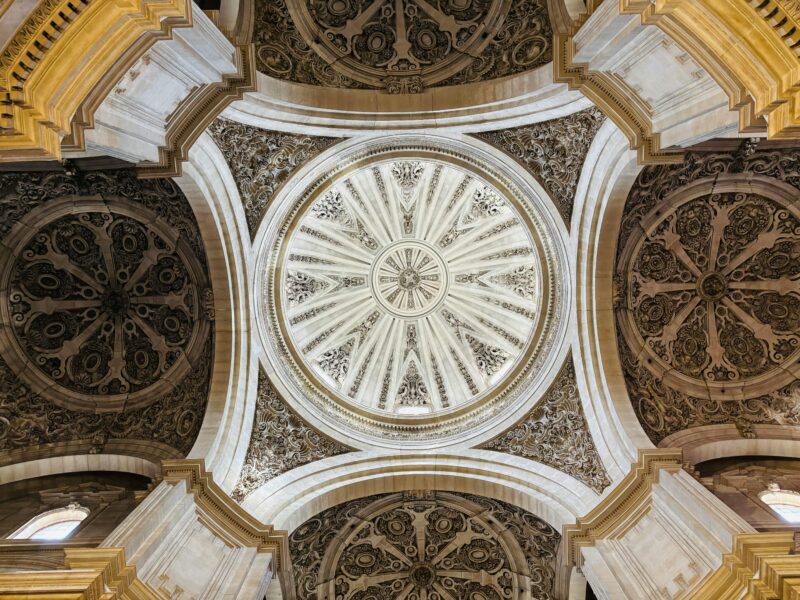 Stunning view of an ornate dome ceiling showcasing intricate architectural designs and patterns.
