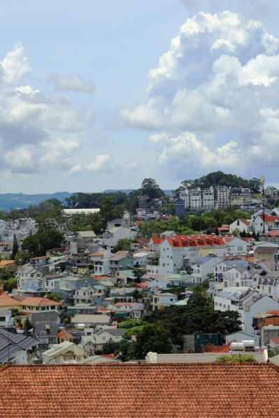 A panoramic view of a colorful cityscape with traditional mixed modern architecture under a beautiful cloudy sky.