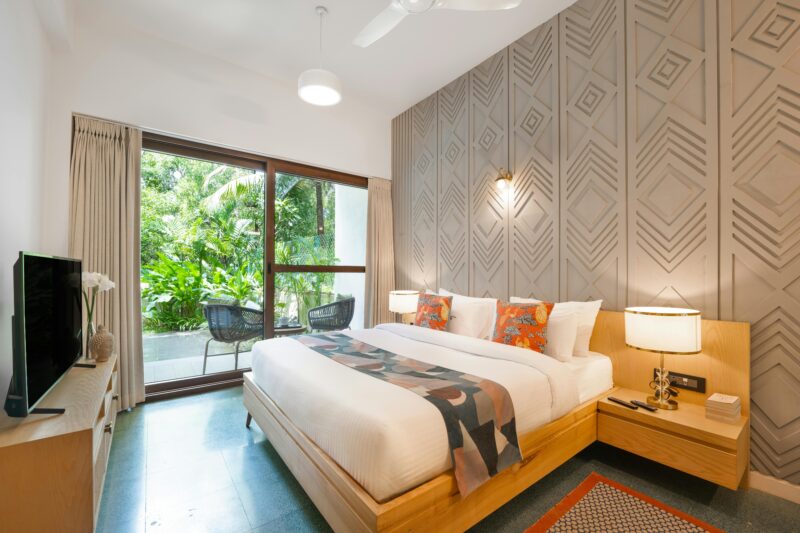 A luxurious modern bedroom in a Goa villa, exemplifying tropical interior design.