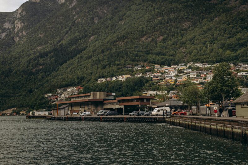 Panoramic view of Odda in Norway, with fjord and mountain backdrop.