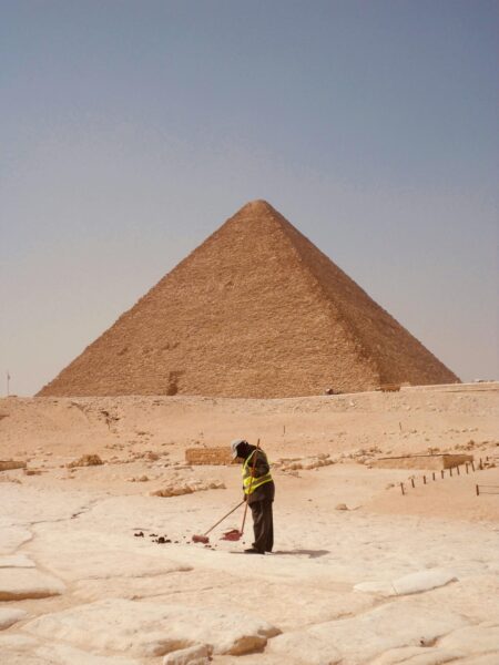 Great Pyramid of Giza with worker in foreground