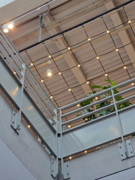 Modern industrial indoor balcony with string lights
