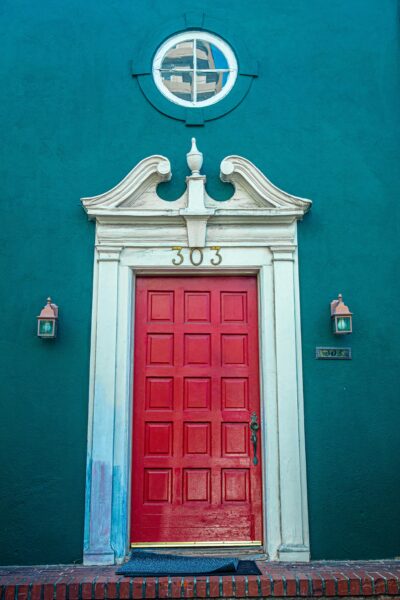 Classic red door on an ornate historic facade in Los Angeles.