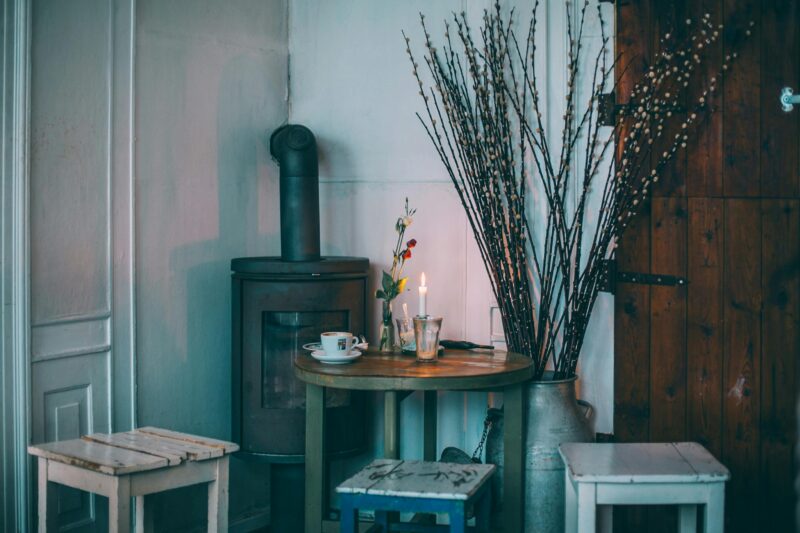 Warm rustic interior featuring a vintage stove and wooden furniture creating a cozy atmosphere.