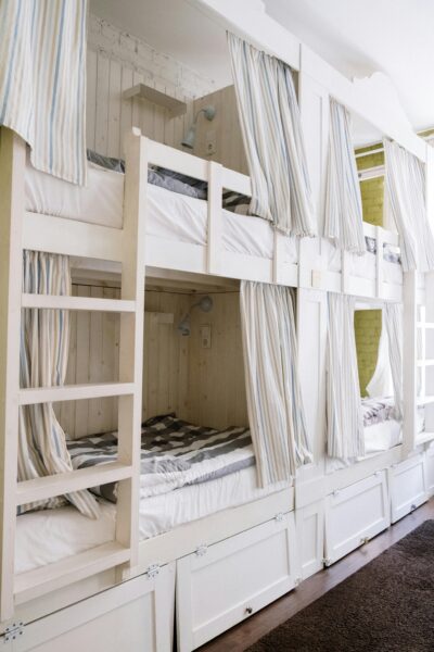 Modern dorm room with bunk beds and built-in storage.