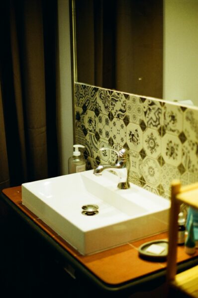 Elegant bathroom featuring a modern sink and ornate patterned tiles.