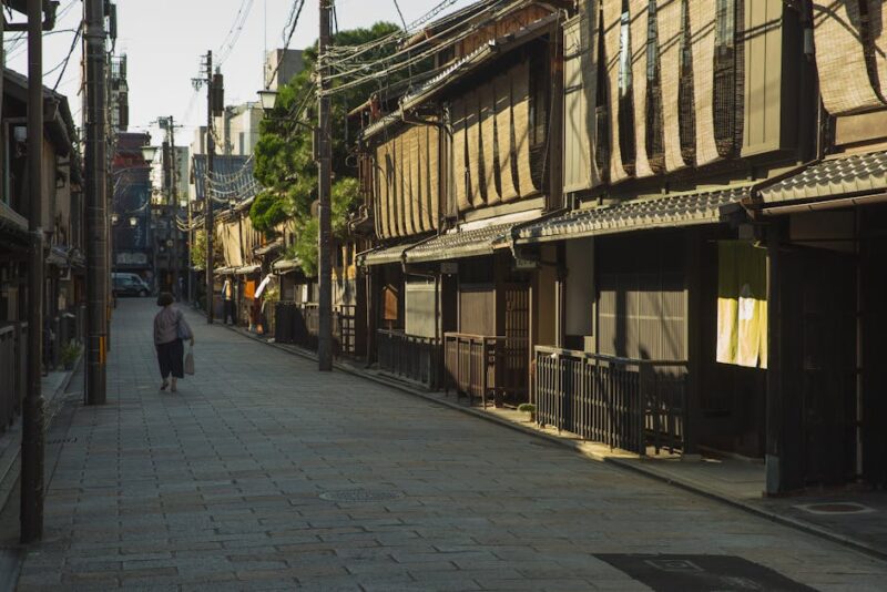 Authentic scene of a peaceful, traditional street in Kyoto's historic Gion district with wooden facades.
