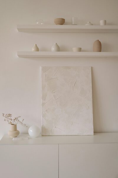 White wooden canvas on white wooden cabinet.