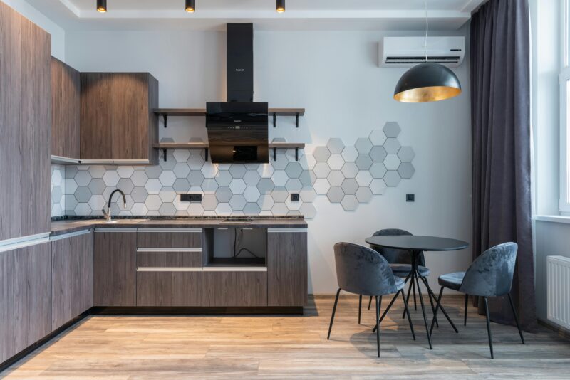 Stylish modern kitchen featuring hexagonal tile backsplash and contemporary furniture