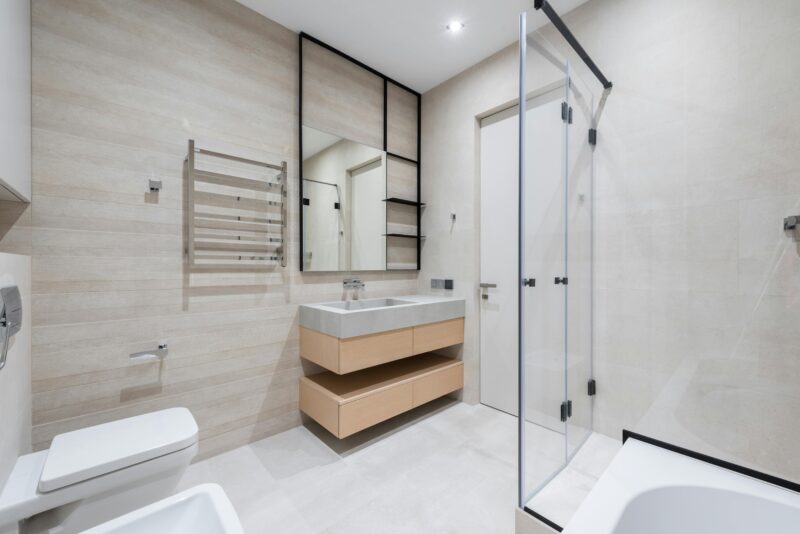 Clean and spacious modern bathroom with minimalist decor and fixtures.