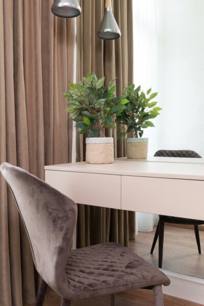 Stylish interior showcasing a cozy velvet chair and decor with plants in a modern setting.