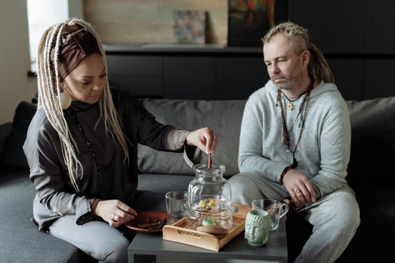 A man and woman sharing a peaceful tea ceremony at home, promoting mindfulness and relaxation.