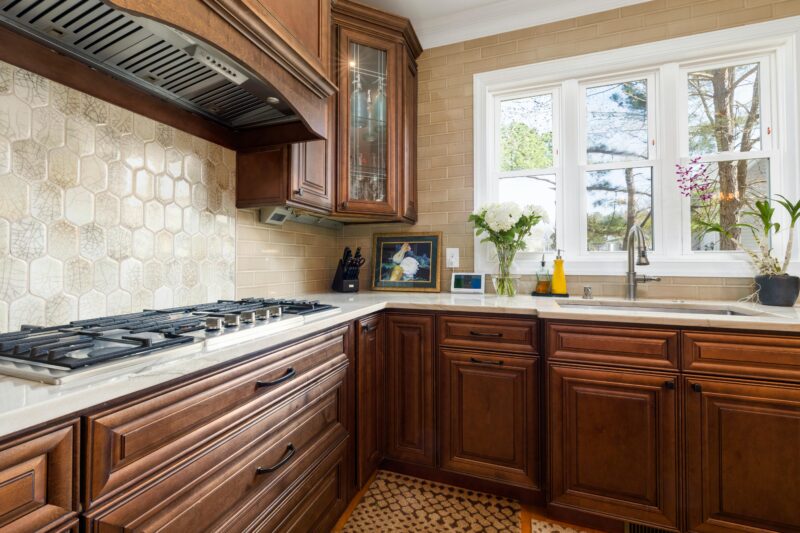 Elegant kitchen featuring classic wooden cabinetry and modern appliances