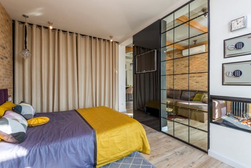 Comfortable bed in a modern bedroom with colorful bed linen