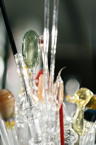 Detailed close-up of colorful glassblowing tools and items, showcasing craftsmanship.