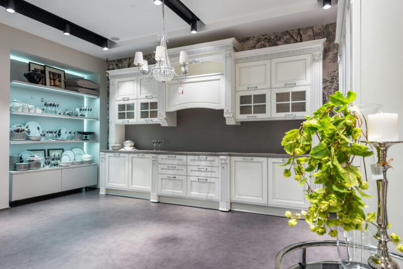 Luxurious white kitchen interior featuring elegant cabinetry and stylish decor.