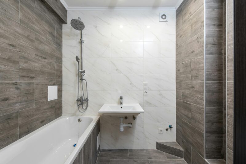Elegant modern bathroom interior with wooden details and sleek design.