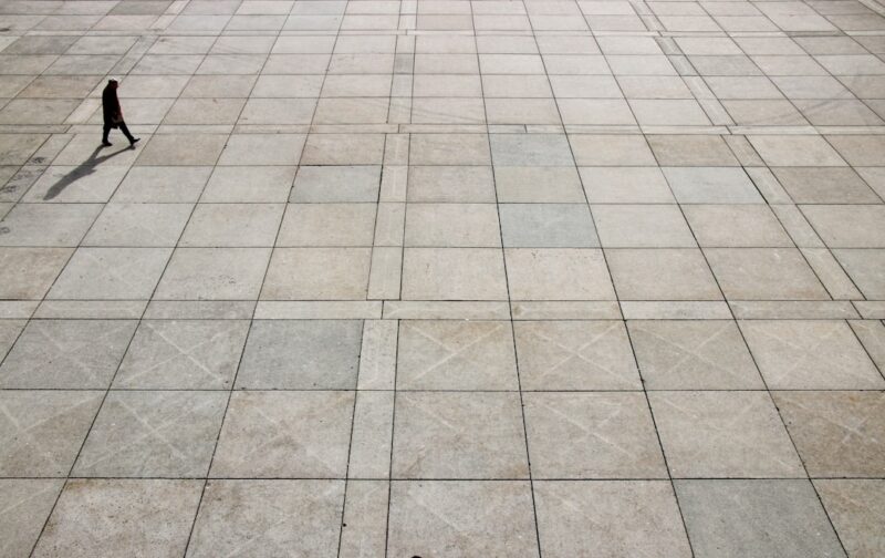 Man walking on tiled ground at daytime