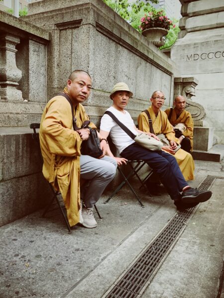 Four men sitting on chairs outdoor during daytime