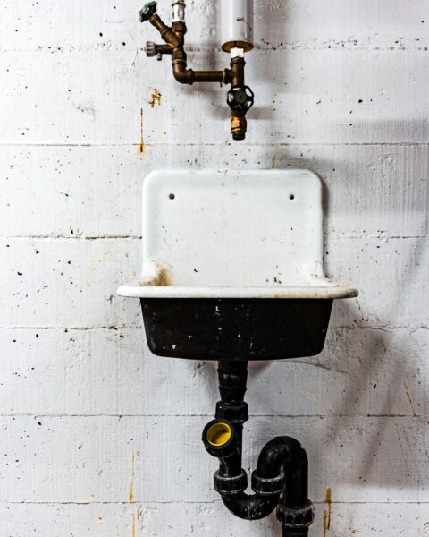 White and black sink beside the wall