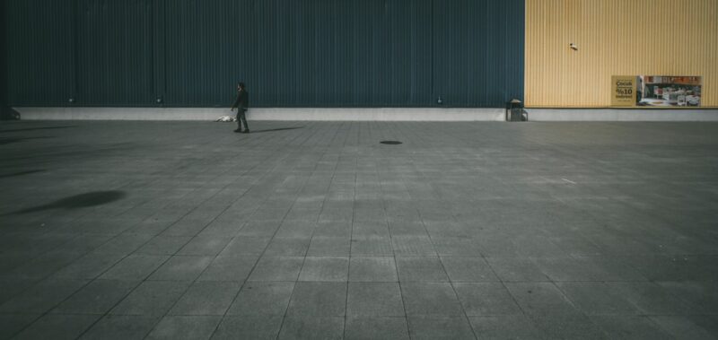 Person walking on concrete pavement.