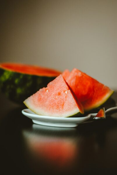 Watermelon slice on white ceramic plate