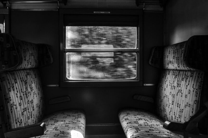 Grayscale photo of train seat.