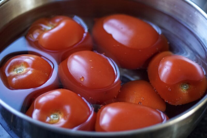 Washing tomatoes to make fresh tomato soup.