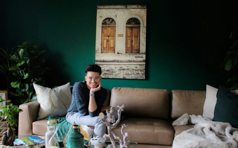 Smiling man sitting on sofa