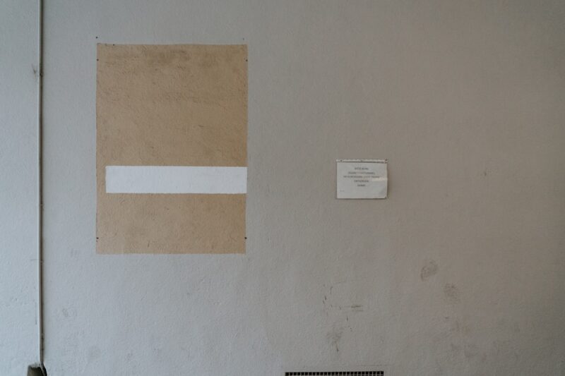 A wall with a piece of paper taped to it