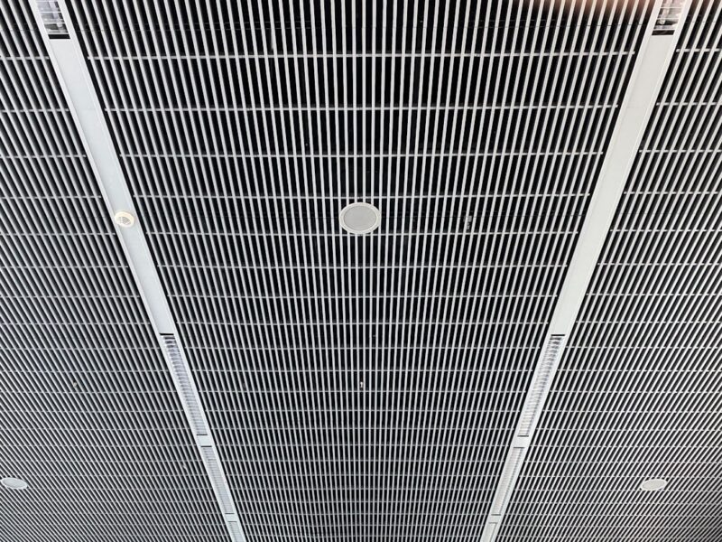 The ceiling of a building with a clock on it