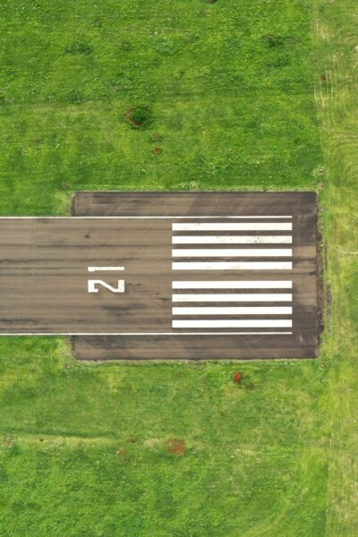 Grey pavement on green grass field