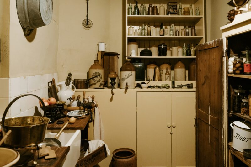 Vases and bottles on a Victorian kitchen shelf.
