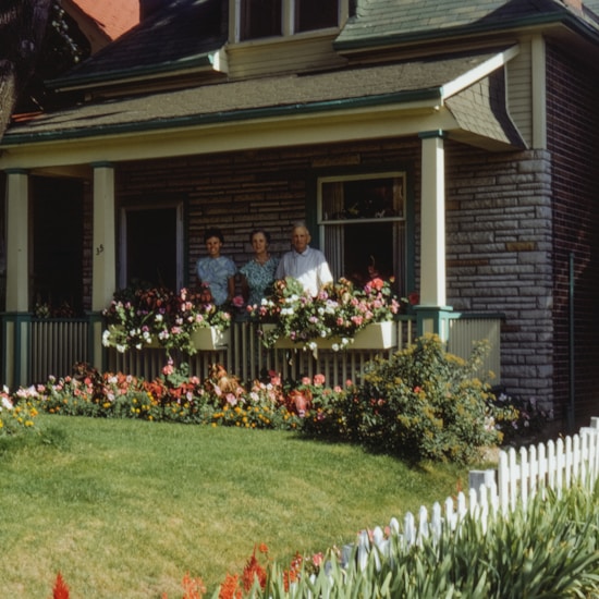 A couple of people standing in front of a house